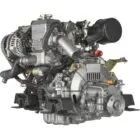 A Yanmar diesel engine with various components and hoses attached.