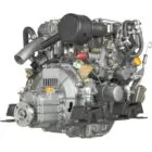 A close-up view of an industrial engine with various mechanical components and hoses.