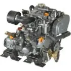 A compact diesel engine with various components and hoses attached.