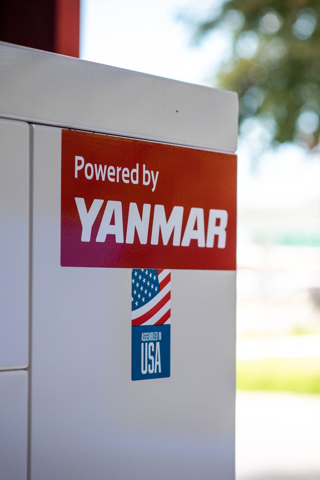 A Powered by YANMAR decal on a generator enclosure